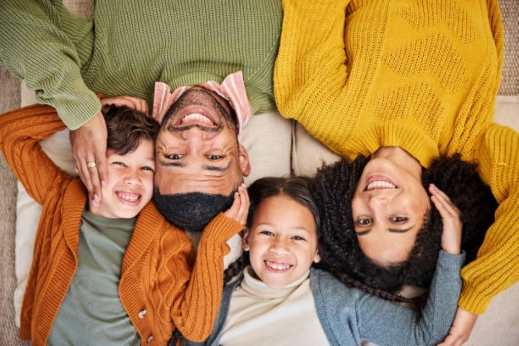Parents and children in trendy clothing smiling together during a family photography session