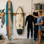 Minimalist surfboard wall rack displayed in a sunny Florida beach home.